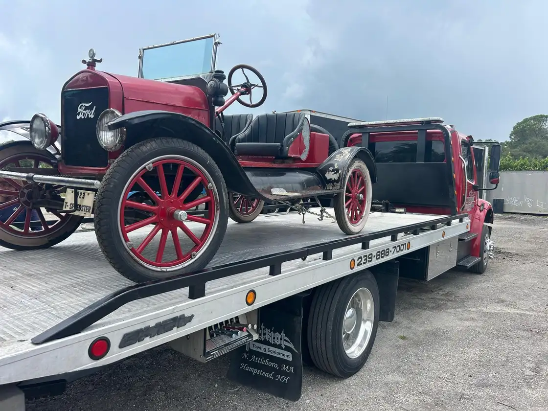 Antique Ford Model T strapped down on the flatbed